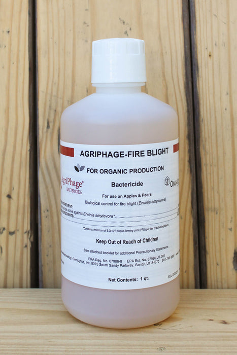 A 1 qt bottle of Agriphage Fire Blight bactericide for apple and pear production, displayed on a wooden surface against a wooden plank background.