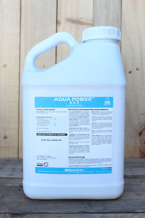 A large white plastic jug of Aqua Power 5-1-1, set against a rustic wooden plank background.
