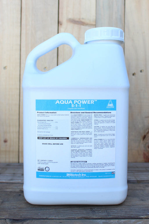 A large white plastic jug of Aqua Power 5-1-1, set against a rustic wooden plank background.