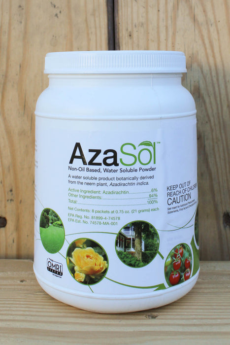A white plastic tub of AzaSol Non-Oil Based, Water Soluble Powder, featuring a white cap and a detailed white label with green accents and botanical imagery, set against a rustic wooden background.