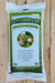 A 44 lb bag of Azomite Granulated Natural Trace Minerals fertilizer, displayed flat on a light-colored wooden plank surface. The packaging is white with a prominent green border and features the brand name 'AZOMITE' in bold green letters with a black outline.