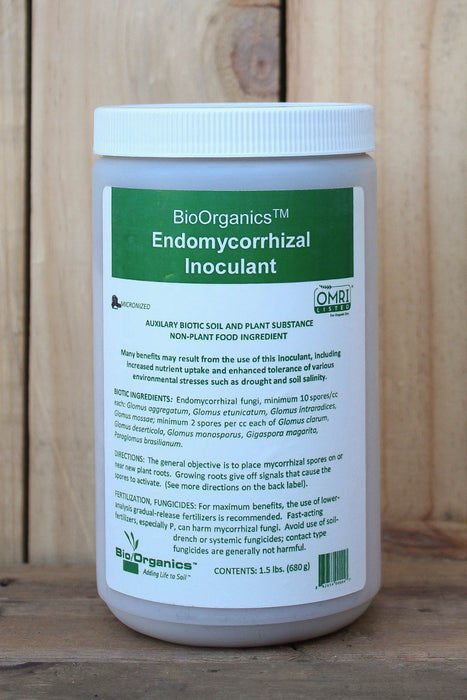 A white plastic bottle of BioOrganics Endomycorrhizal Inoculant with a green and white label, set against a light wood background.