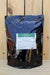 A stand-up pouch of BioOrganics Endomycorrhizal Inoculant, featuring a shiny black and blue reflective bag with a white and green label, set against a light wood plank background.