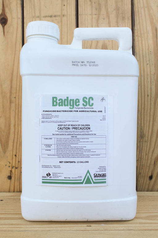 A 2.5-gallon white plastic jug of Badge SC fungicide and bactericide, displayed against a light wood plank background.