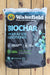 A 1 cu ft bag of Wakefield Biochar Premium Soil Conditioner, displayed flat on a light-colored wooden plank surface. The packaging is primarily black with blue and white text, featuring the Wakefield brand logo and a graphic of green leaves.