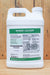 A white plastic jug of Biomin Calcium liquid fertilizer by JH Biotech Inc., featuring a green and white label, set against a rustic wooden plank background.