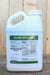 A large white plastic jug of BIOMIN MANGANESE, set against a rustic wooden plank background.