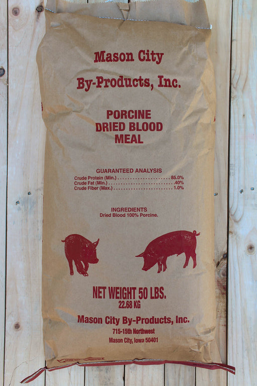 A 50 lb bag of Mason City By-Products, Inc. porcine dried blood meal, shown against a light wood plank background.