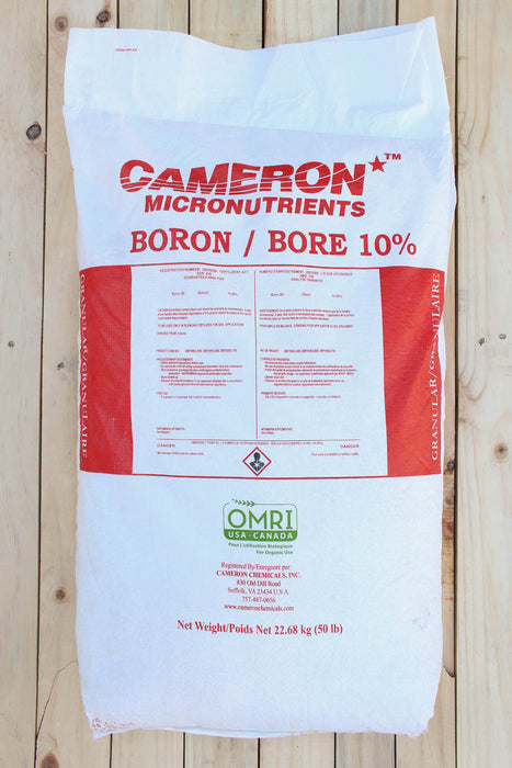 A large white bag of Cameron Micronutrients Boron / Bore 10% fertilizer, displayed flat on a light-colored wooden plank background.