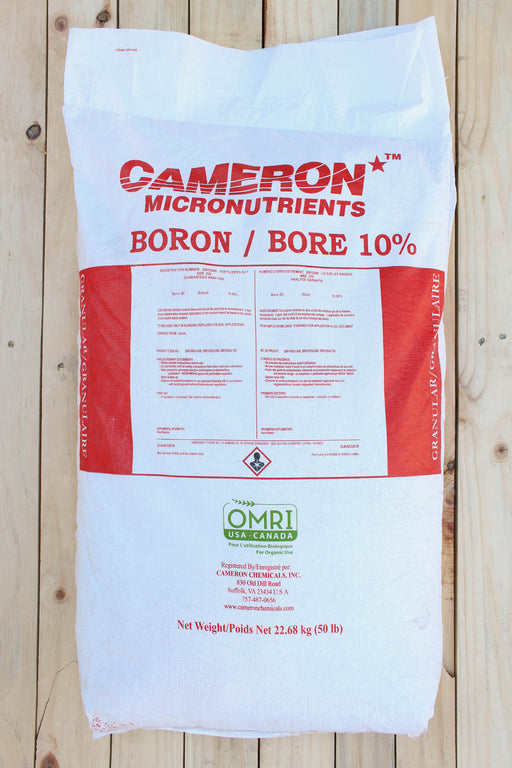 A large white bag of Cameron Micronutrients Boron / Bore 10% fertilizer, displayed flat on a light-colored wooden plank background.