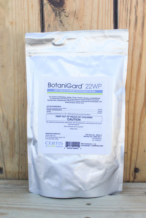 A silver stand-up pouch of BotaniGard 22WP, displayed against a rustic wooden plank background.