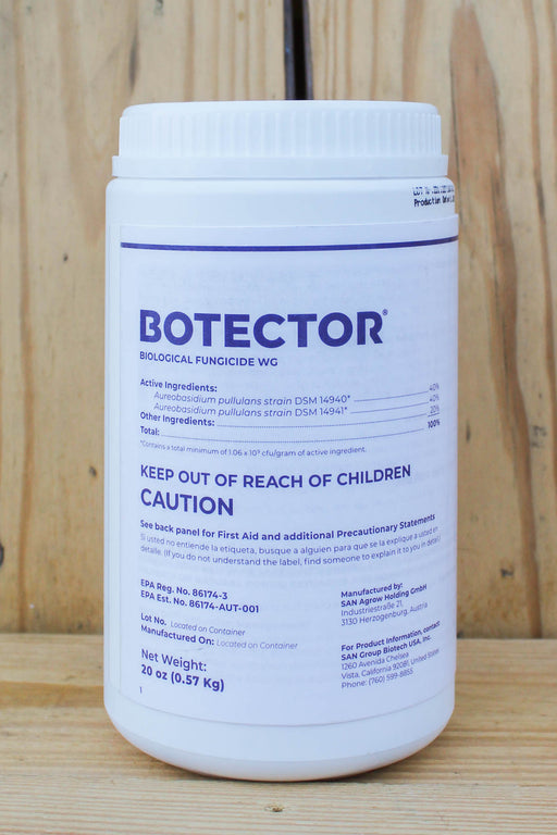 A white plastic bottle of Botector Biological Fungicide WC with blue text, standing on a light-colored wooden surface.