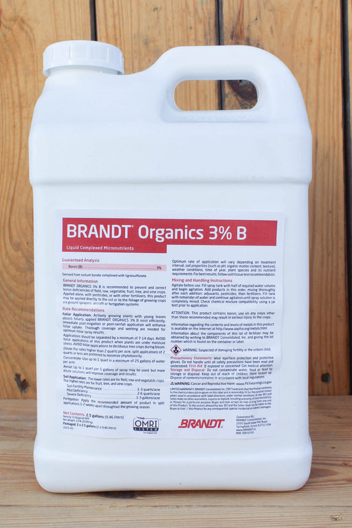 A large white plastic jug of BRANDT Organics 3% Boron, standing upright against a rustic wooden plank background.