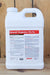 A large white plastic jug of Brandt Organics 5% Iron fertilizer, standing upright against a rustic wooden plank background.