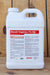 A large white plastic jug of Brandt Organics 7% Mn liquid fertilizer, featuring a white cap and a detailed red and black label, set against a rustic wooden plank background.