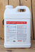 A large white plastic jug of Brandt Organics Tree & Vine Mix with a detailed label, set against a rustic wooden plank background.