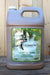 A large plastic jug of Brown's Liquid Fertilizer Organic Gardening, filled with a brownish liquid, set against a rustic wooden plank background.