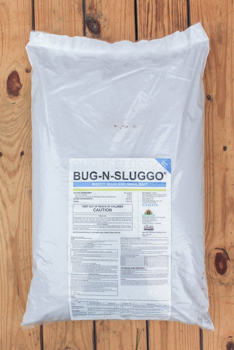 A large white plastic bag of Bug-N-Sluggo slug and grub control product, featuring a detailed label, placed on a wooden plank surface.