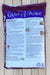 A bag of Coast of Maine organic compost, showing the back panel with product details, text, and a small photo, placed on a light wood surface.