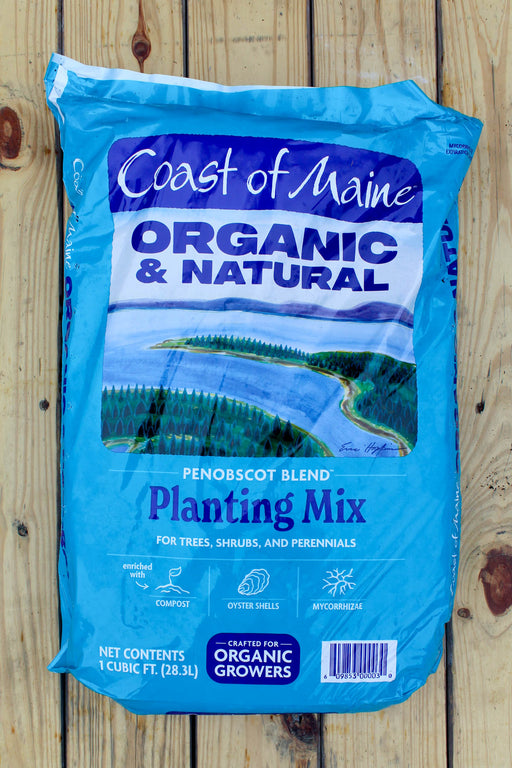 A blue bag of Coast of Maine Organic & Natural Penobscot Blend Planting Mix, displayed flat on a light-colored wooden plank surface.