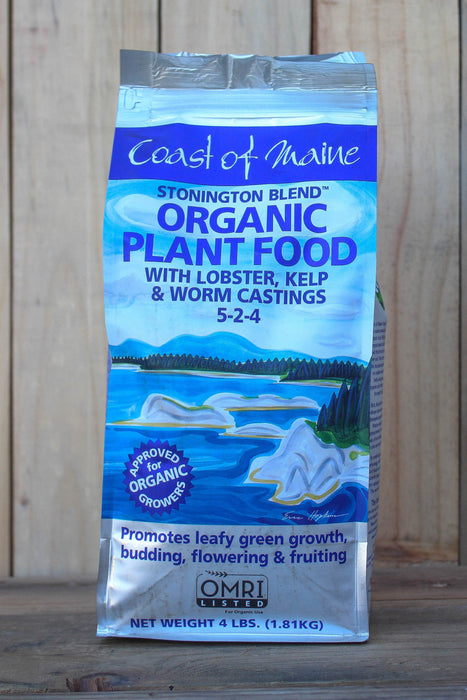 A 4 lb bag of Coast of Maine Stonington Blend Organic Plant Food with lobster, kelp, and worm castings, displayed against a vertical wood plank background.