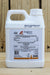 A white plastic jug of Gowan Captiva Prime, featuring a detailed product label, set against a rustic wooden background.
