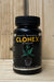 A black plastic bottle of CLONEX Rooting Gel with a black ribbed cap, set on a light wood surface against a light wood plank background. The label features the brand name 'CLONEX' in yellow, 'Growth Technology' in white, and an illustration of a green plant with a root system.