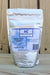 A 1 lb stand-up pouch of Alpha Chemicals Copper Sulfate Pentahydrate Powder, set against a rustic wooden plank background.