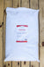 A large white bag of Crab Meal placed on a wooden plank surface.