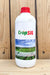 A white plastic bottle of CropSIL with a red cap, standing on a wooden surface against a wooden plank background.