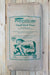 A large paper bag of Perma-Guard Fossil Shell Flour anti-caking agent, featuring green text and illustrations of farm animals on a beige background, photographed against a light wood plank wall.