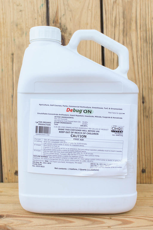 A large white plastic jug of Debug ON, displayed on a wooden surface against a wooden plank background.