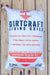 A large white bag of Dirtcraft Living Soils Levitation Seedling Mix, displayed flat against a light-colored wooden plank background.