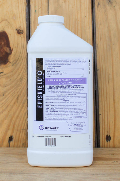 A white plastic bottle of BioWorks Epishield O insecticide and miticide, shown from the back against a rustic wooden plank background.