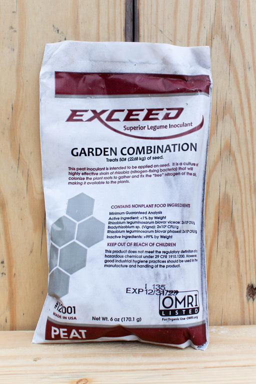 A bag of Exceed Garden Combination Peat inoculant, displayed on a light-colored wooden surface.