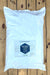 A large white plastic bag of Ferti Organic Soluble Seaweed Extract Plus, placed flat on a light brown wooden plank surface.