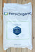 A large white plastic bag of Ferti-Organic Ferti-Nitro Plus fertilizer, laid flat on a light-colored wooden plank surface. The bag features the Ferti-Organic brand name and logo in dark blue and green, with a central label showing the product name and a blue hexagonal graphic.