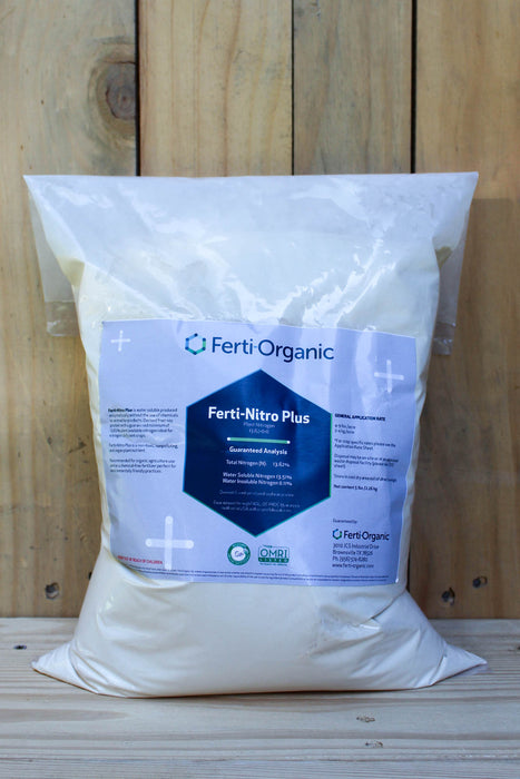 A large white plastic bag of Ferti Organic Ferti-Nitro Plus fertilizer, standing upright against a light-colored wooden plank background.