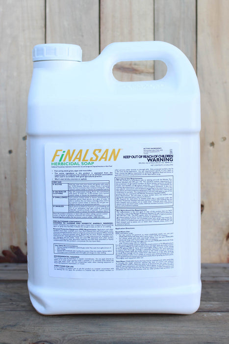 A large white plastic jug of Finalsan Herbicidal Soap standing on a wooden surface against a light wood plank background.