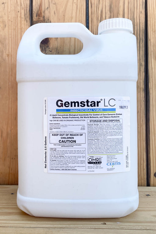 A 2.5-gallon white plastic jug of Gemstar LC Insecticidal Virus, featuring a detailed product label, set against a rustic wooden plank background.