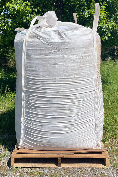 A white tote of material on a pallet.
