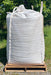 A white tote of material on a pallet.