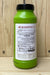 A green plastic bottle of Grandevo with a black cap, standing on a light wood surface against a wood panel background.