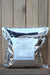A large silver foil bag with a white label reading 'GRANDEVO WDG' sits on a wooden surface against a wooden plank background.