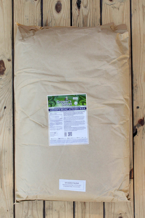 A large brown paper bag of Grower's Secret with a white and green label, placed on a light-colored wooden plank surface.