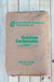 A 50 lbs brown paper bag of Calcium Carbonate, featuring green text and logo, placed flat on a light-colored wooden plank background.