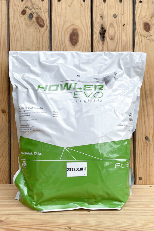 A 15 lb bag of Howler EVO fungicide, featuring a white and green packaging design, set against a rustic wooden plank background.