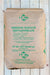 A 50 lbs bag of Copper Mountain Ferrous Sulfate Heptahydrate on a white wood plank background.