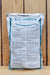 A large silver bag of Kaligreen standing upright against a light wood plank background. The front label is mostly white with teal text and borders, featuring the brand name KALIGREEN prominently at the top.