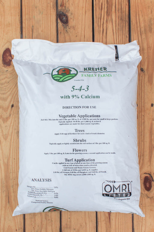 A 40 lb white bag of Krehmer Family Farms 5-4-3 fertilizer with 9% Calcium, displayed on a rustic wooden plank background.